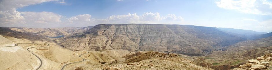 Vista de um mirante ao norte do rio Arnom (Imagem panorâmica de 180° do Wadi Mujib). À esquerda está a barragem de Al Mujib (ao fundo), à direita o rio continua em direção ao Mar Morto